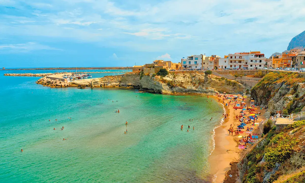 La spiaggia di Terrasini, con la sua scalinata che scende verso il mare cristallino, è un luogo incantevole per godersi il sole e fare il bagno.