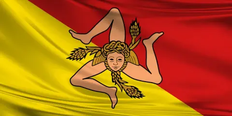 Bandiera siciliana con la Trinacria. Chi esce, riesce a raggiungere i propri obiettivi con determinazione.