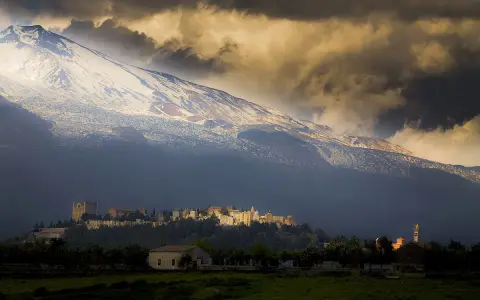 Villaggio ai piedi dell'Etna, vulcano imponente. L'etimologia del nome "Etna" evoca un fuoco eterno, come quello che arde sotto la neve.