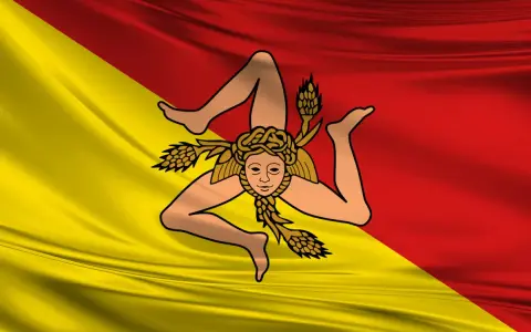 Bandiera siciliana con la Trinacria. Chi esce, riesce a raggiungere i propri obiettivi con determinazione.
