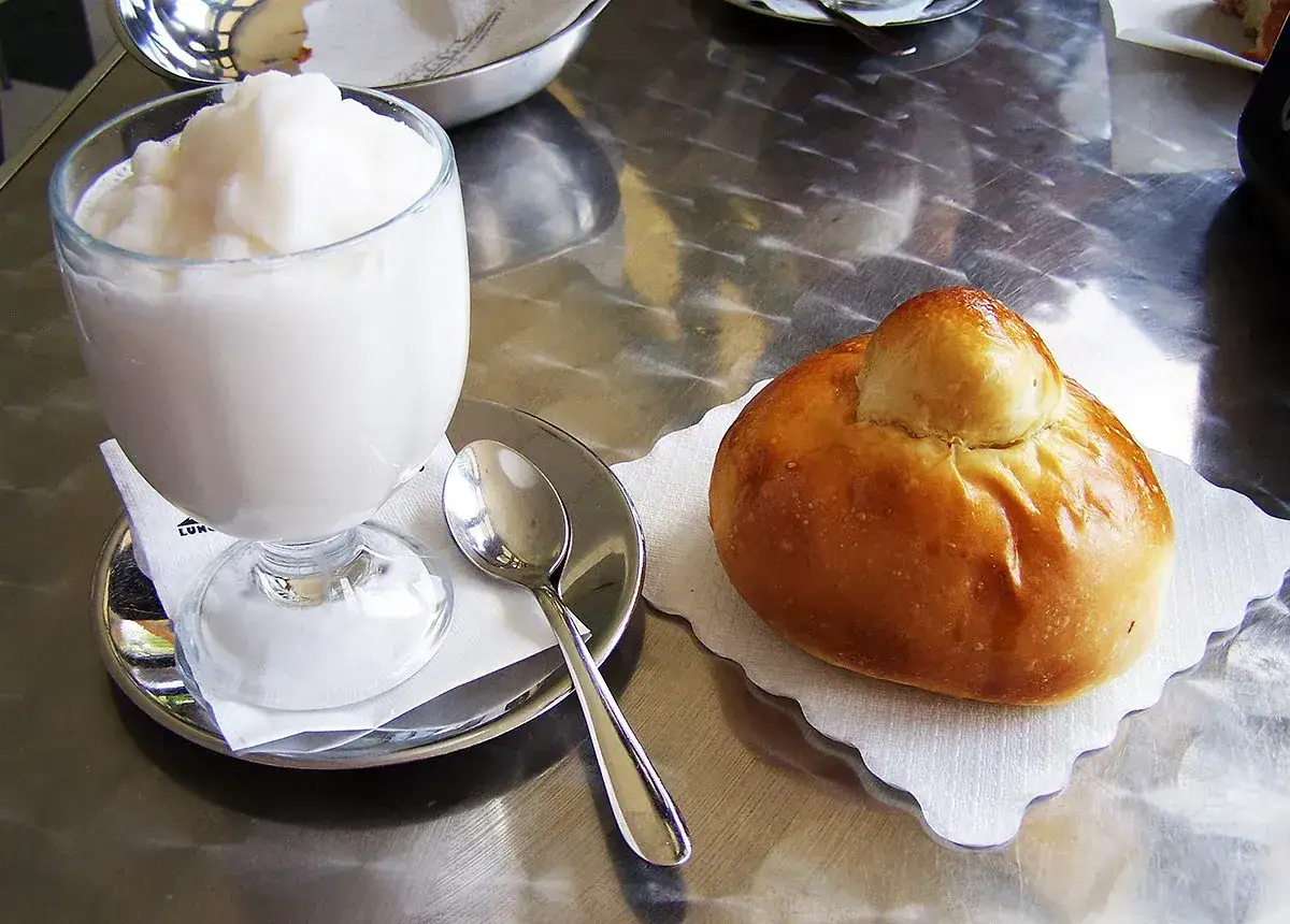 Granita al limone e brioche col tuppo, un classico dei piatti tipici siciliani per una colazione perfetta.